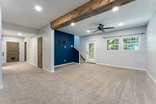 a bathroom with a granite countertop toilet sink and mirror