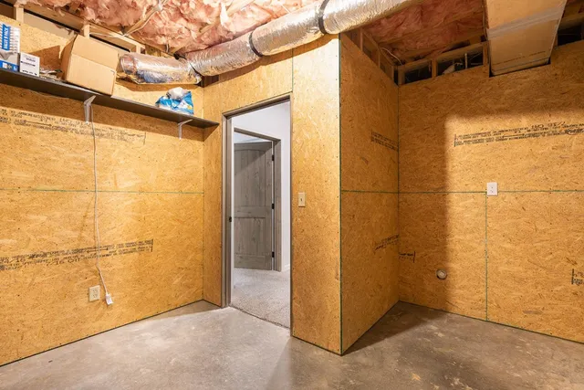 a view of a yard with plants and trees