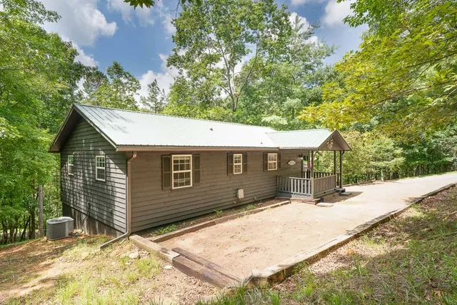 a backyard of a house with lots of trees