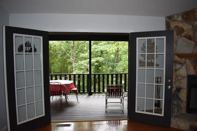 a view of a kitchen with a sink a kitchen an empty room and wooden floor
