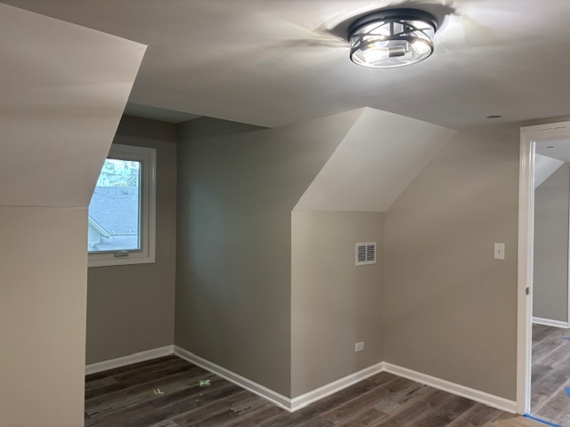 456 Franklin Boulevard Elgin, IL 60120 - Photo 22 of 32 an empty room with wooden floor cabinet and hallway
