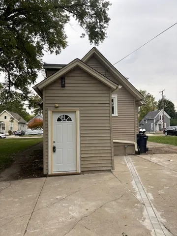 a view of a house with a yard and garage