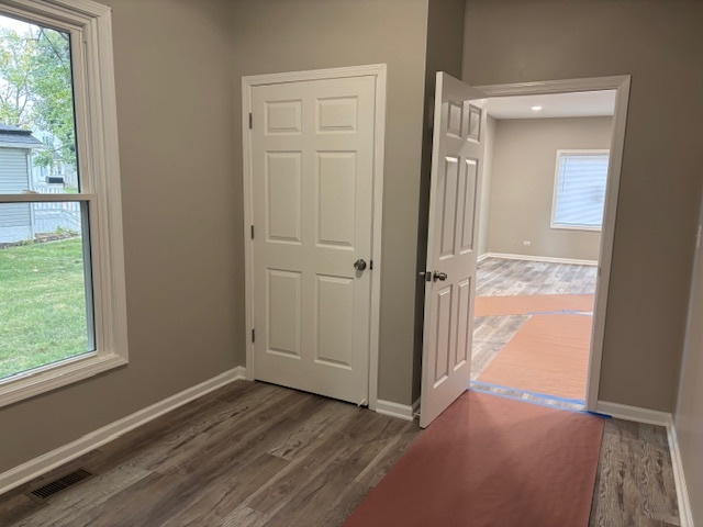 456 Franklin Boulevard Elgin, IL 60120 - Photo 10 of 32 an empty room with wooden floor front door