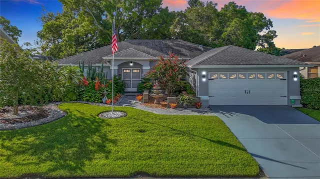 a aerial view of a house next to a yard