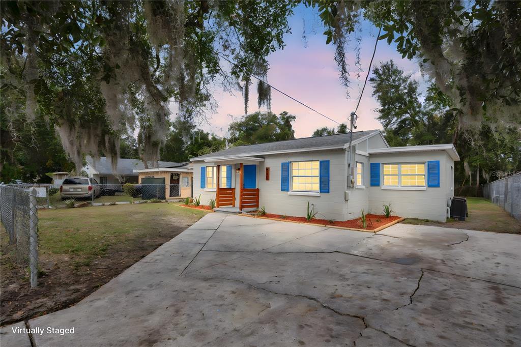 911 Indiana Street Orlando, FL 32805 - Photo 2 of 24 a view of a house with backyard and trees