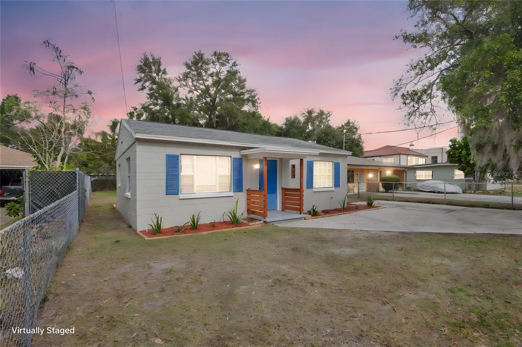 911 Indiana Street Orlando, FL 32805 - Photo 3 of 24 a front view of a house with a yard and garage