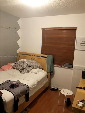 a bedroom with a bed and chair