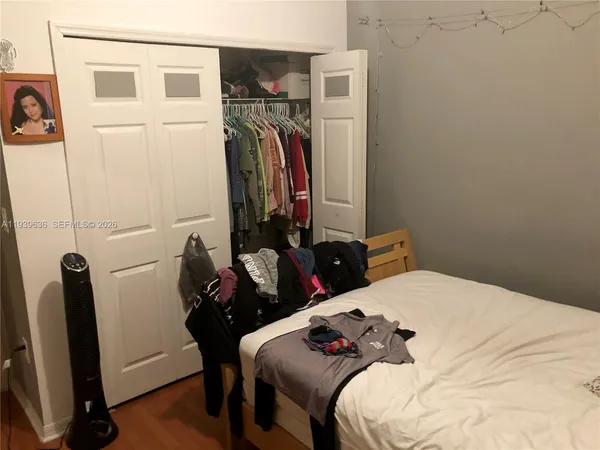 a bedroom with a bed and a mirror