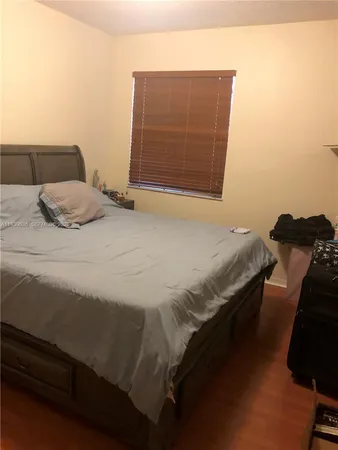 a bedroom with a bed and dresser