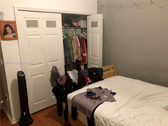 a bedroom with a bed and a mirror