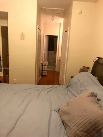 a bedroom with a bed and a mirror