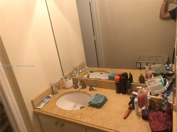 a bathroom with a sink and mirror
