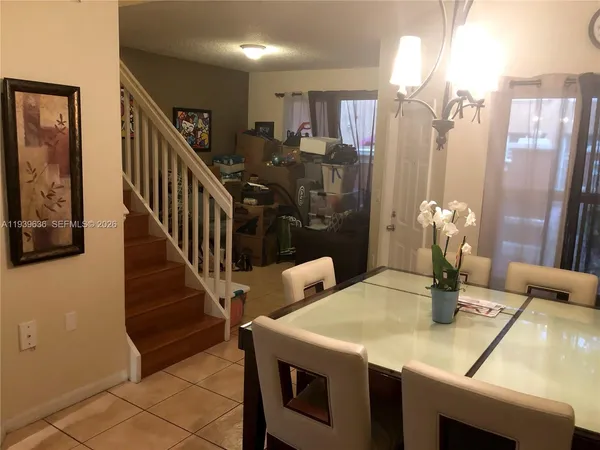 a dining room with furniture and window