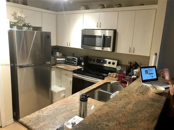 a kitchen with a refrigerator and a sink