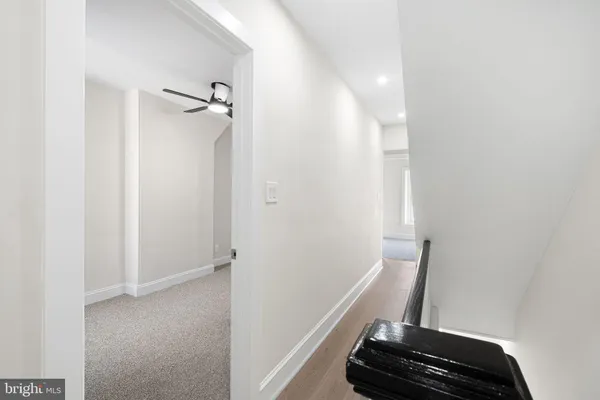 an empty room with a ceiling fan and a bathroom