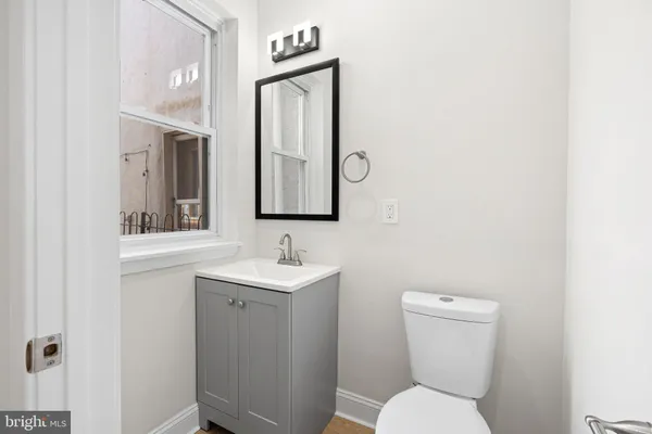 a kitchen with granite countertop a sink and cabinets