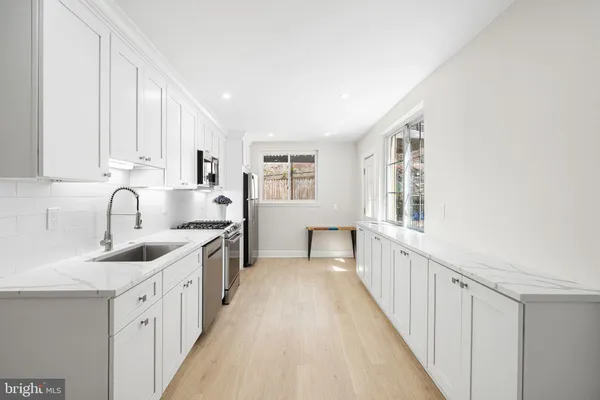 a kitchen with granite countertop a stove and a sink