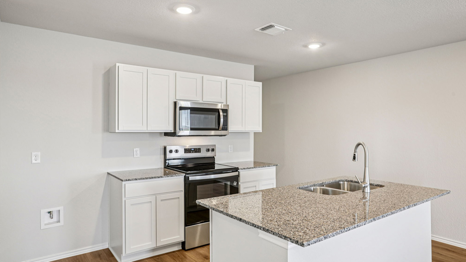 148 Wyatt Way Jarrell, TX 76537 - Photo 3 of 33 Kitchen featuring white cabinetry, stainless steel appliances, granite countertops, and wood-finish flooring