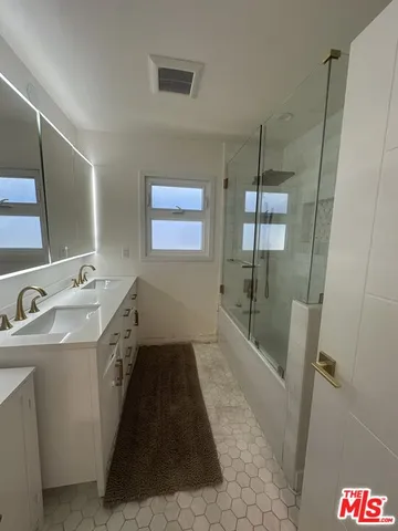 a bathroom with sink and mirror