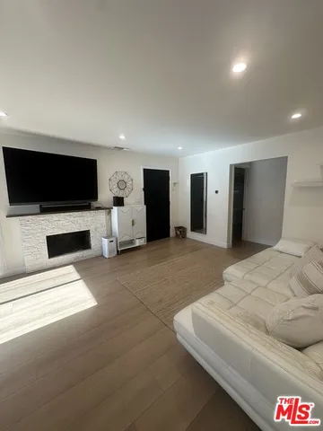 a bedroom with a bed and a flat screen television