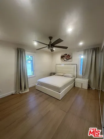 a spacious bedroom with a bed and a chandelier