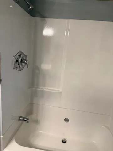 a bath tub sitting next to a white sink