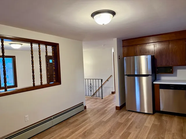 a view of a refrigerator in kitchen and wooden floor