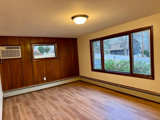 wooden floor in an empty room with a window