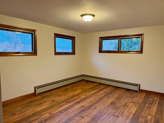 a view of a room with wooden floor and fan