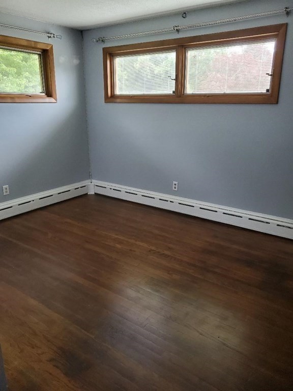 107 Davis Road Westport, MA 02790 - Photo 12 of 26 a view of an empty room with wooden floor and a window