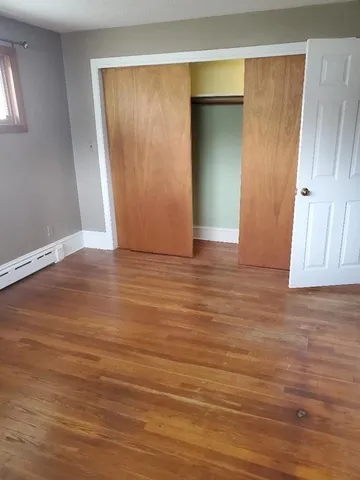an empty room with windows and closet