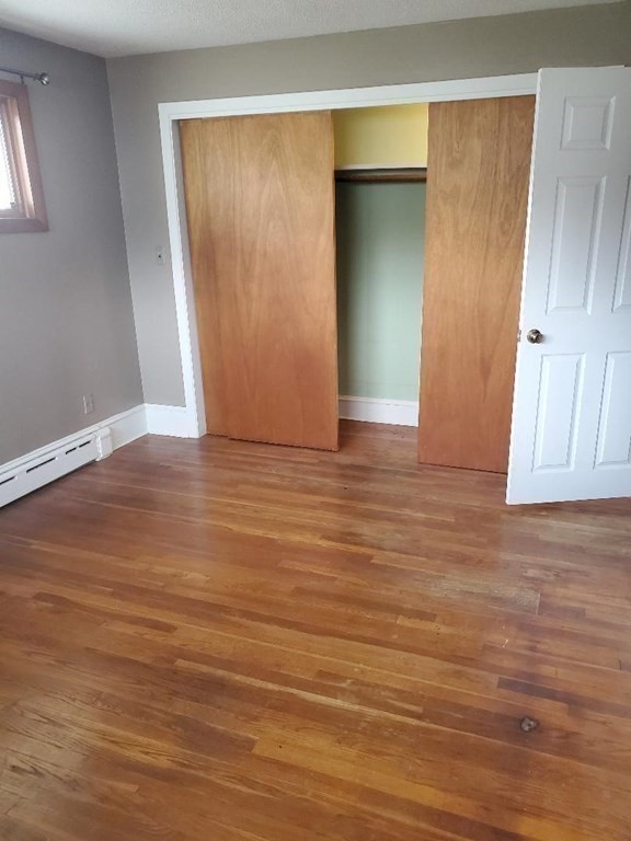 107 Davis Road Westport, MA 02790 - Photo 14 of 26 an empty room with wooden floor and windows