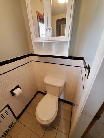 a bathroom with a toilet a sink and a window