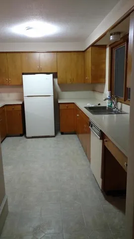 a kitchen with a sink and a stove top oven