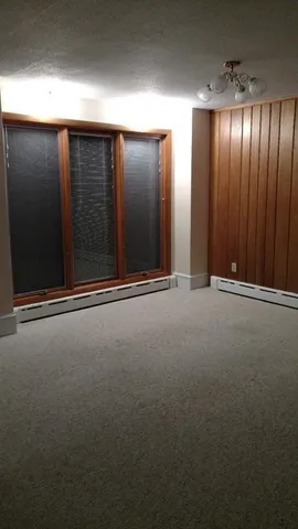 a view of empty room with a fireplace