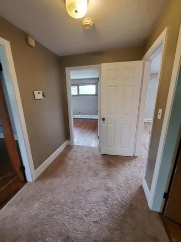 a view of a room with wooden floor and window