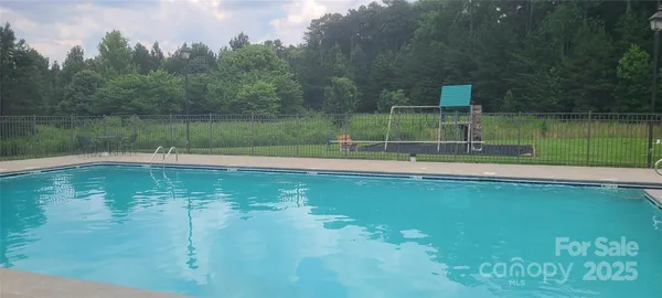 a view of a swimming pool with an outdoor space and seating area