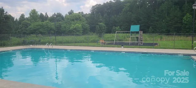 a view of a swimming pool with an outdoor space and seating area