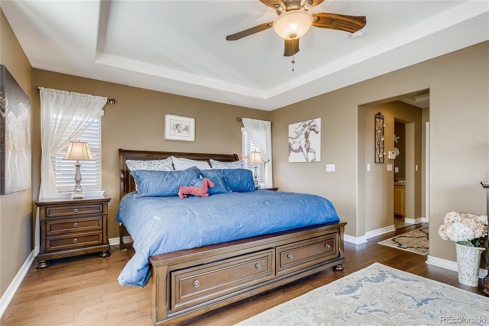 9198 Viaggio Way Highlands Ranch, CO 80126 - Photo 17 of 37 a bedroom with a bed and wooden floor