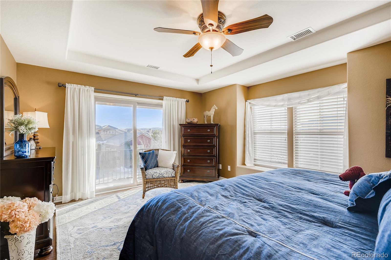 9198 Viaggio Way Highlands Ranch, CO 80126 - Photo 18 of 37 a bedroom with a bed and a chandelier