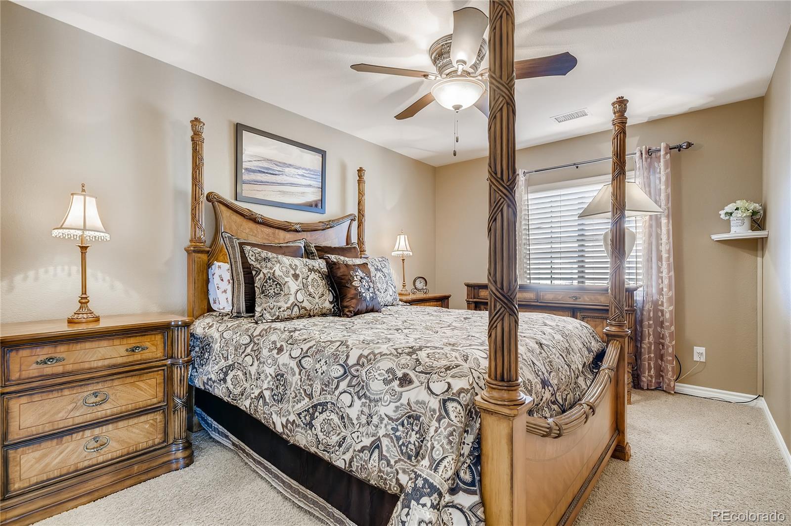 9198 Viaggio Way Highlands Ranch, CO 80126 - Photo 23 of 37 a bedroom with a bed and a table