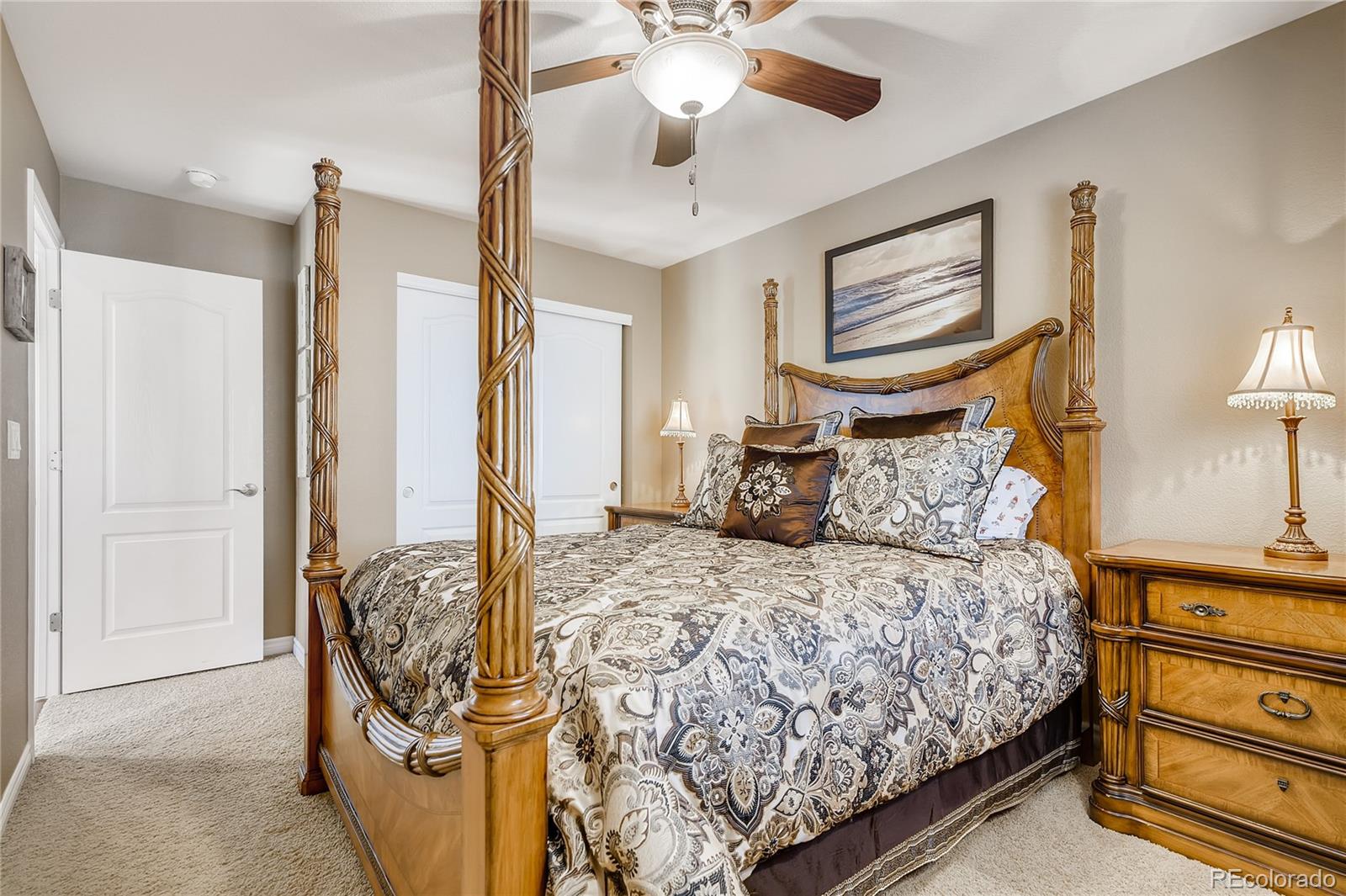 9198 Viaggio Way Highlands Ranch, CO 80126 - Photo 24 of 37 a bedroom with a bed and a chandelier