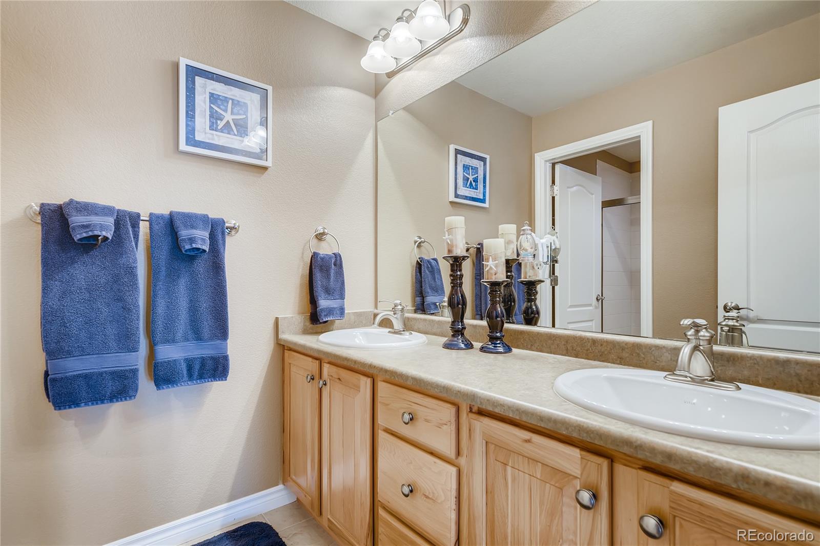9198 Viaggio Way Highlands Ranch, CO 80126 - Photo 25 of 37 a bathroom with a double vanity sink and a mirror