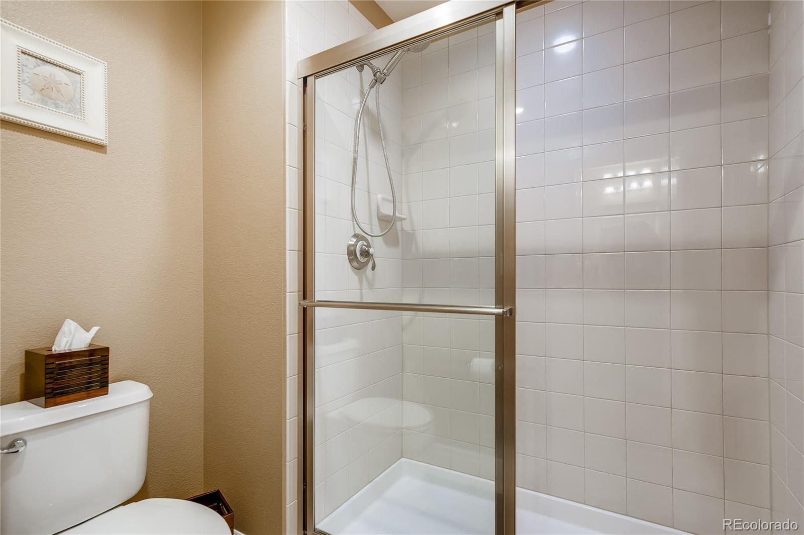 9198 Viaggio Way Highlands Ranch, CO 80126 - Photo 26 of 37 a bathroom with a shower and toilet