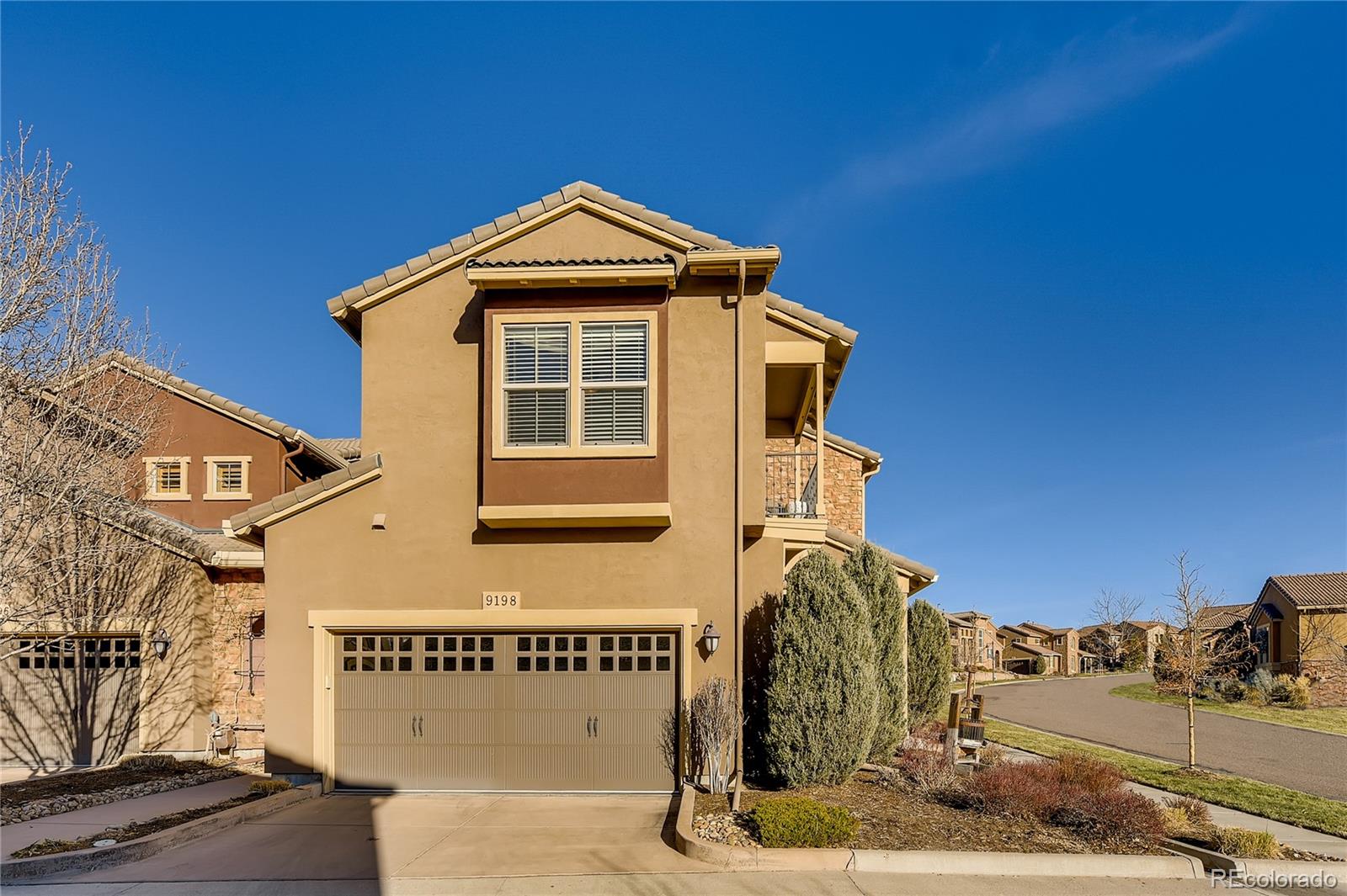 9198 Viaggio Way Highlands Ranch, CO 80126 - Photo 28 of 37 a front view of a house with a yard