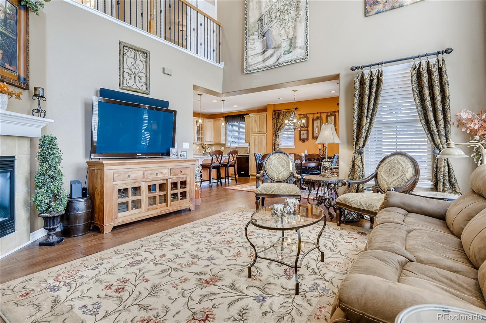 9198 Viaggio Way Highlands Ranch, CO 80126 - Photo 5 of 37 a living room with furniture and a fireplace