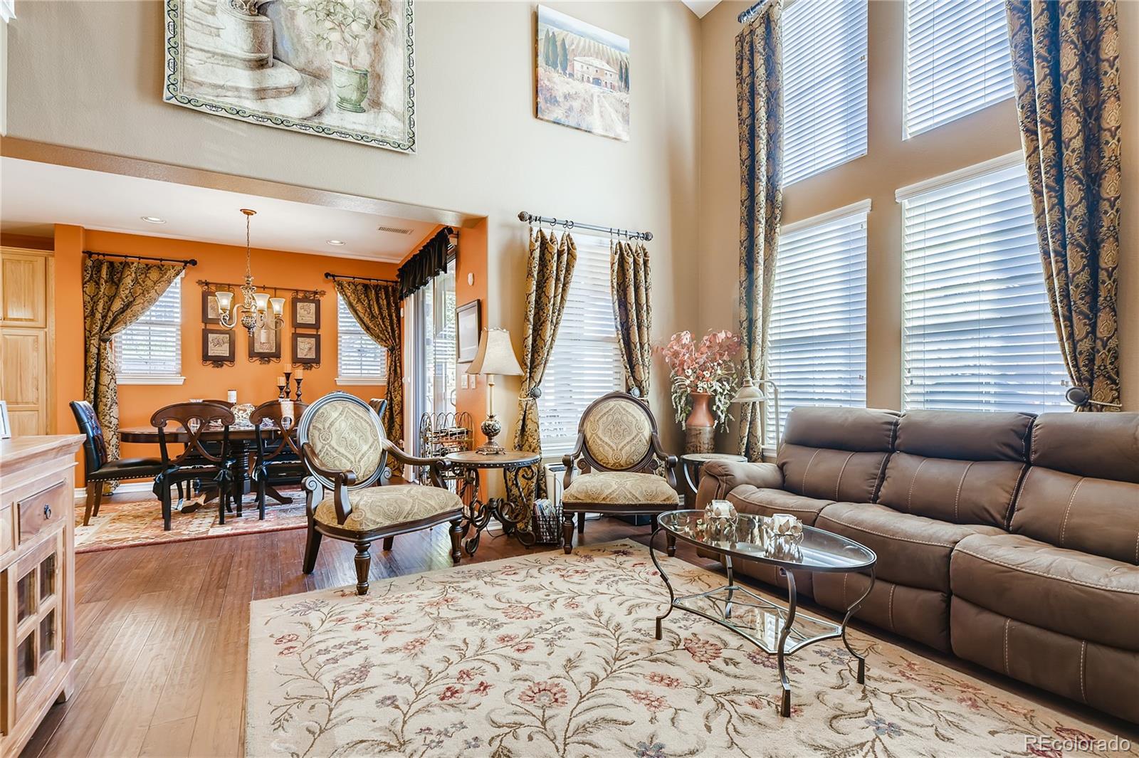9198 Viaggio Way Highlands Ranch, CO 80126 - Photo 6 of 37 a living room with furniture and wooden floor