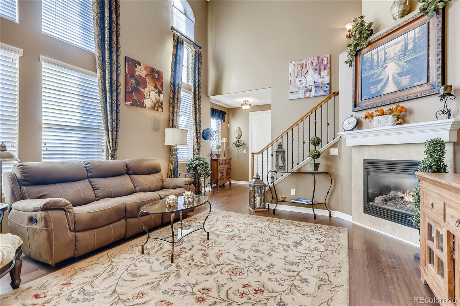 9198 Viaggio Way Highlands Ranch, CO 80126 - Photo 7 of 37 a living room with furniture and a fireplace