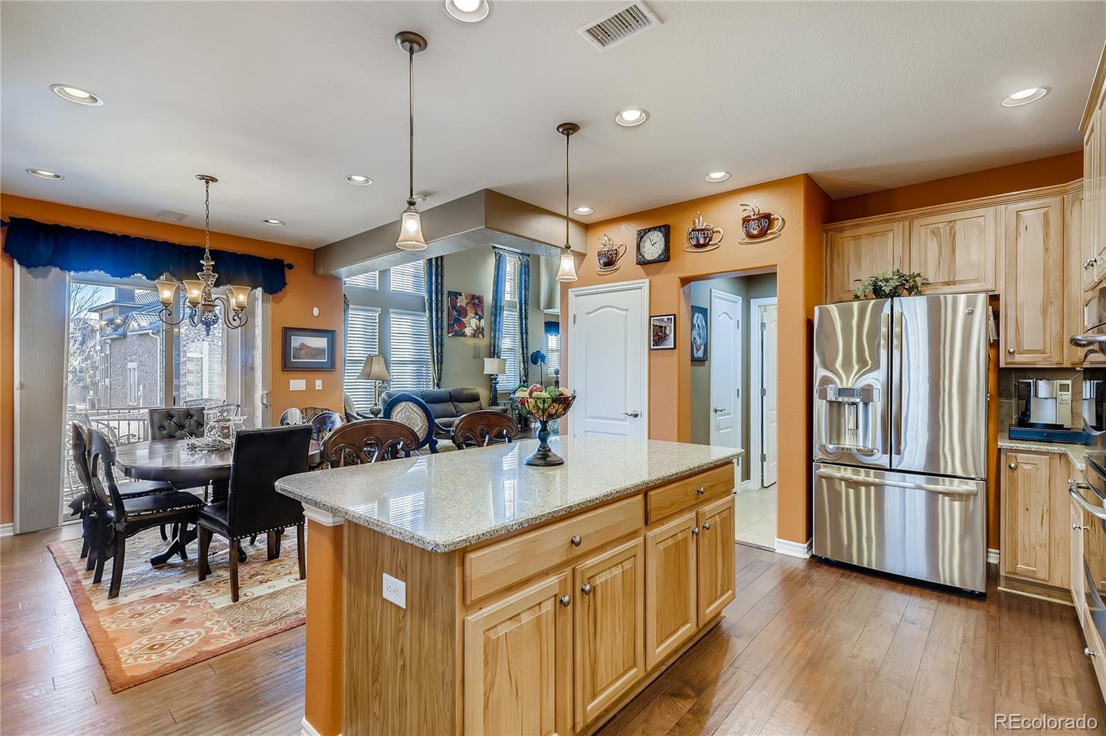 9198 Viaggio Way Highlands Ranch, CO 80126 - Photo 10 of 37 a kitchen with stainless steel appliances granite countertop a refrigerator a stove and a sink