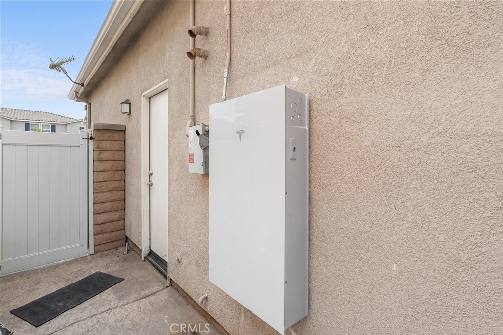 20948 Center Street Riverside, CA 92507 - Photo 65 of 92 a white house with refrigerator and door
